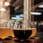 Two dark beers on tap table