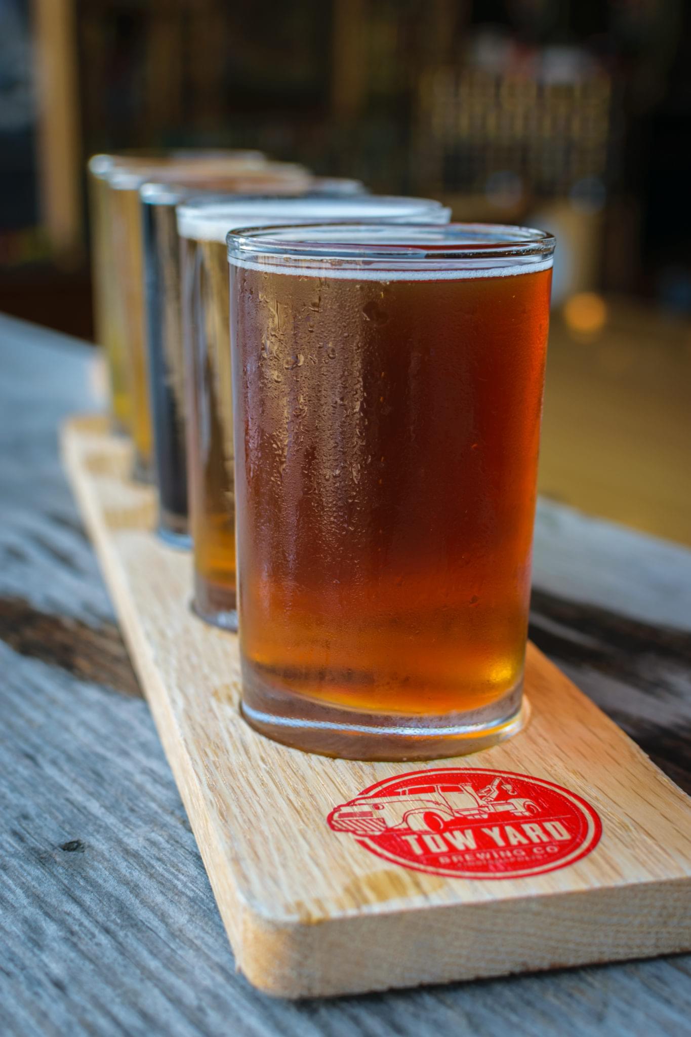 Freshly poured amber beer served in a glass on a coaster