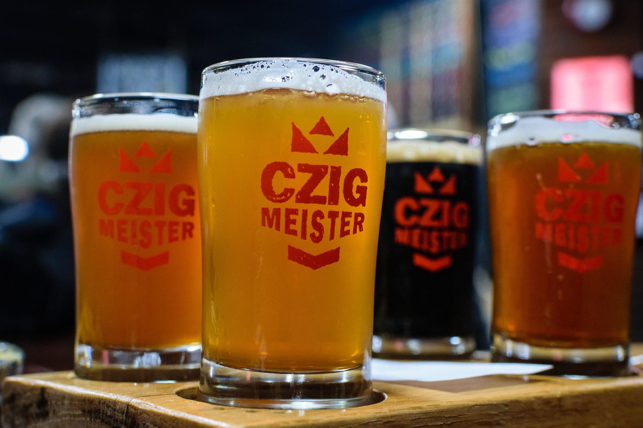 Pint of golden craft beer served on a brewery bar counter