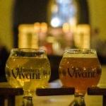Glass of craft beer served on a wooden table inside a brewery
