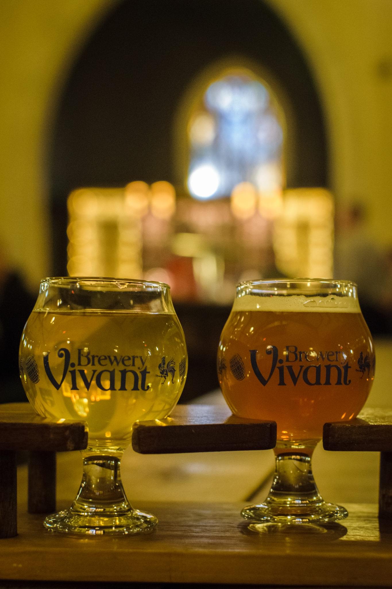 Glass of craft beer served on a wooden table inside a brewery