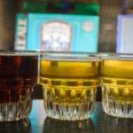 Multiple pints of beer lined up on bar counter